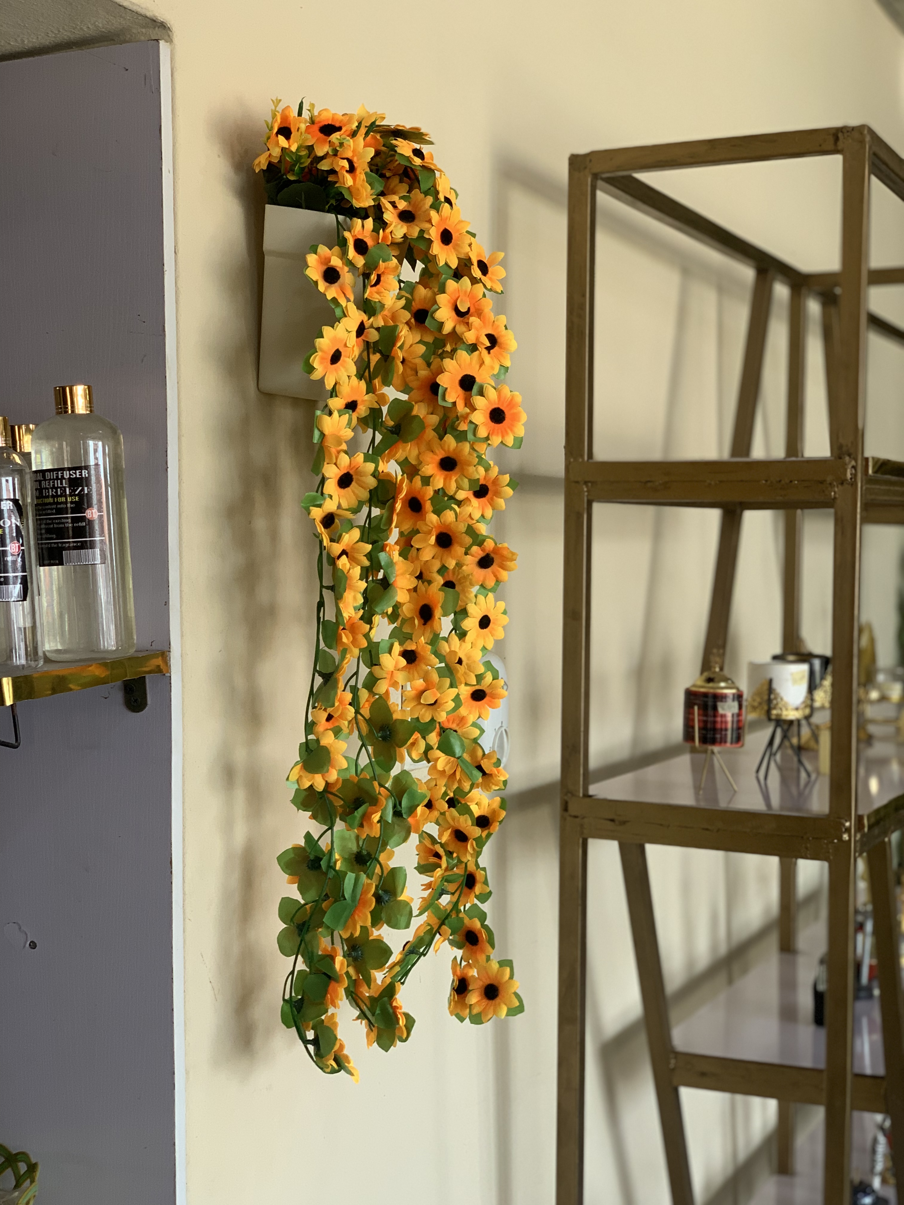 Dropping sunflowers in plastic wall vase Image